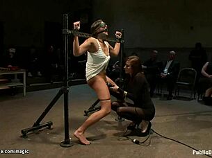 bound slave endures rough treatment in public