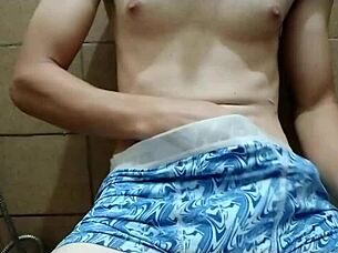 Rubbing my cock in the kitchen bathroom, massaging it hard until I orgasm.