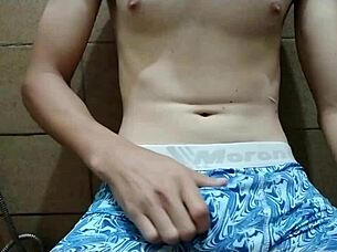 Rubbing my cock in the kitchen bathroom, massaging it hard until I orgasm.