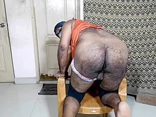 a nice big ass gently inserting a small black toy in a relaxed setting