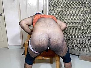 a nice big ass gently inserting a small black toy in a relaxed setting