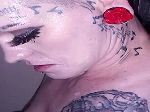 Lyrik Allure Performs Sloppy Blowjob Through Gloryhole, Receives Facial Cumshot on Her Hairless Body