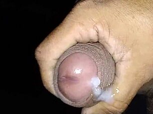 Hispanic guy strokes his big cock to cumshot.