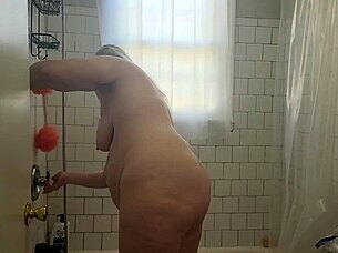 hey, check out momma vee shaving her pussy smooth and then playing with herself in the shower, those big natural tits bouncing