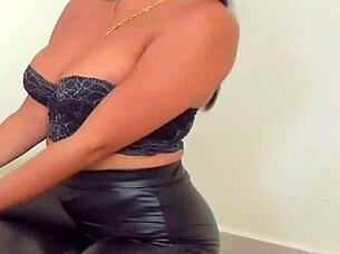 Detailed view of shiny leggings on a fashion model in a neutral setting.