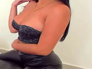 Detailed view of shiny leggings on a fashion model in a neutral setting.