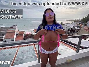 I'm showing off tight shorts and transparent micro bikini on hotel terrace with Krisshotwife.