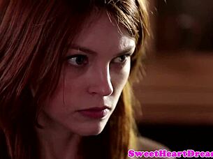 A redheaded lesbian babe is gently seduced into intimate acts.