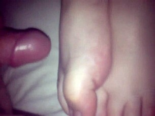 Amateur performs footjob on cock in 69 position, stroking with feet