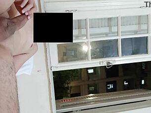 flashing cock at open window for neighbors