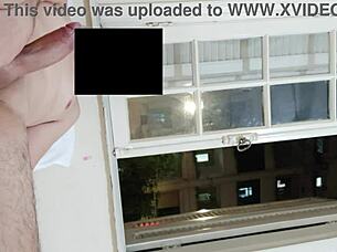 flashing cock at open window for neighbors