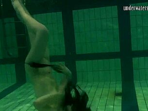 Brunette teen swims naked in pool, tight pussy exposed.