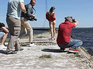 naked woman poses nude on the public dock in outdoor reality setting
