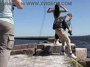 naked woman poses nude on the public dock in outdoor reality setting