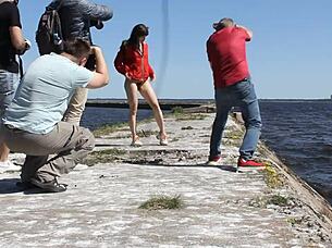 naked woman poses nude on the public dock in outdoor reality setting