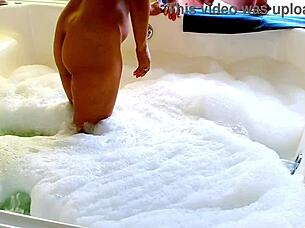 In jacuzzi, black woman with big tits enjoys blowjob and sex