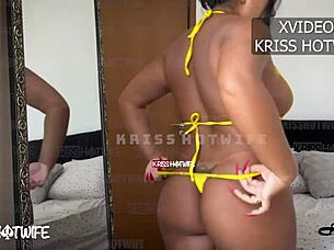 Hot girl experimenting with new micro bikinis on the beach.