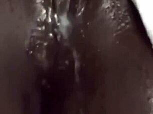 The ebony babe uses a huge vibrator for homemade masturbation and squirting.