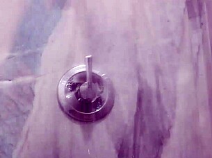 in the shower, she sucks on the shower head passionately