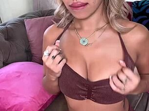 Is Luna Luxe masturbating with her pink vibrator on the sofa?