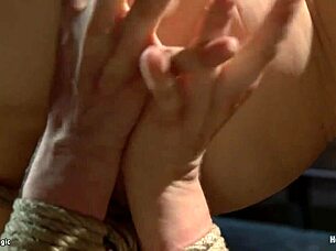 this busty blonde is hung by her ankle in a hogtied position for some reason