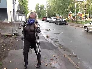 Sexy milf walks outdoors in nylon outfit.