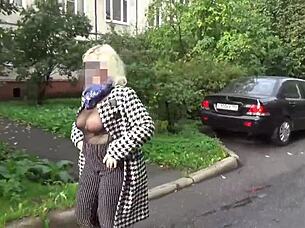 Sexy milf walks outdoors in nylon outfit.